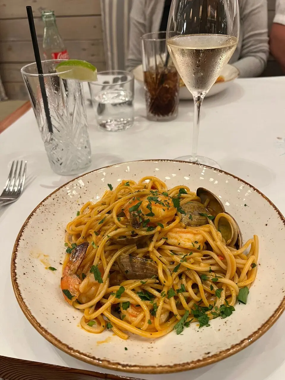 Scala Osteria signature dishes Scialatielli with Clams and Shrimp, Pork Chop Milanese, Grilled Branzino.